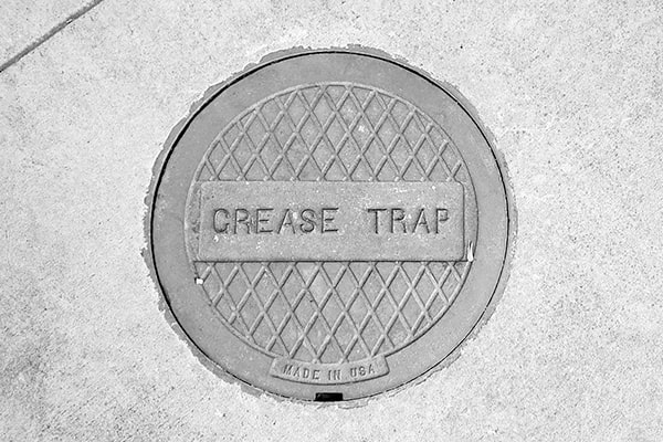 grease trap pumping entails the removal of grease, oils, and solid waste from grease traps to prevent clogs and backups in the plumbing system